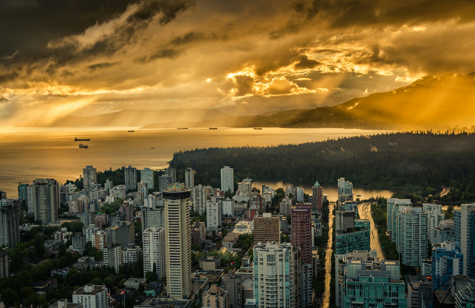 Vancouver photographed from the air at sunset, with rain clouds sweeping across the skyline