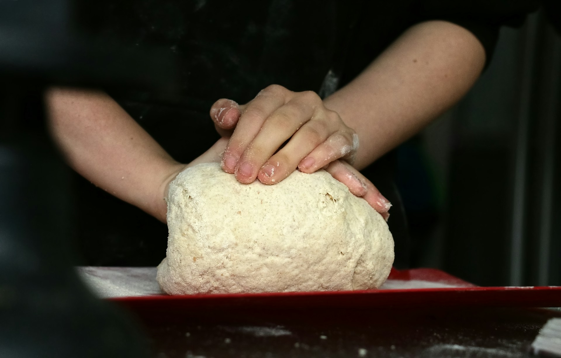 Close up of hands kneading bread