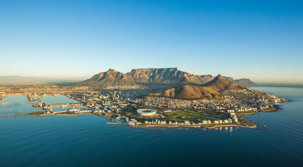 An aerial photo of Cape Town, looking towards the city from out over the ocean