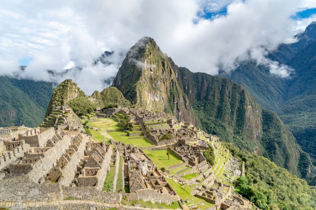 Image of Machu Picchu In Peru, with low lying cloud and sunshine