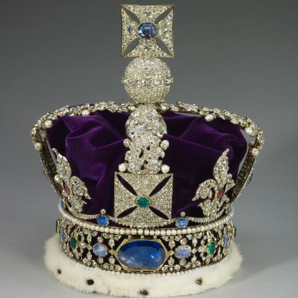Image of the Imperial State Crown of the British monarchy. Purple in color with jewels including a large blue stone at the front