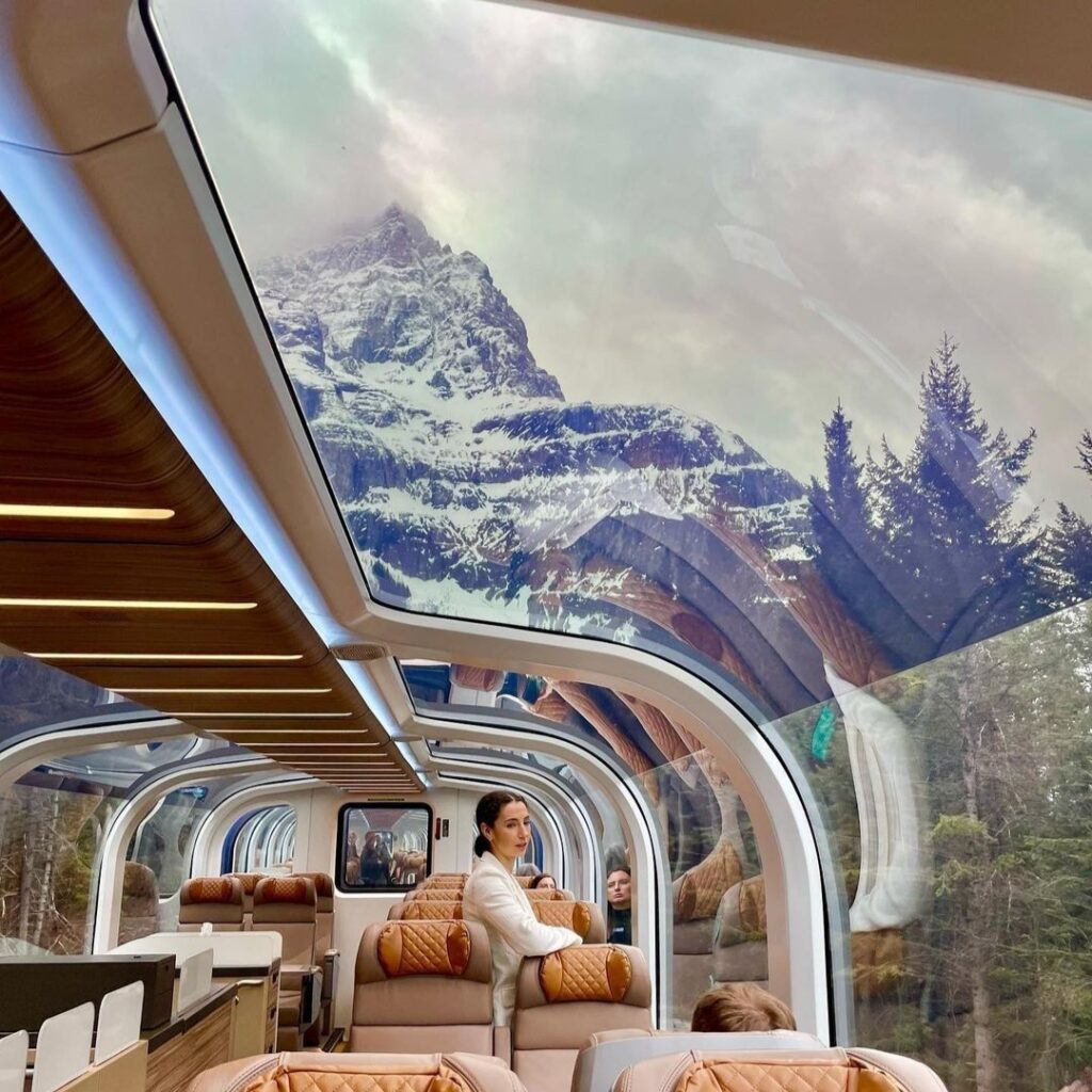 Image of Rocky Mountaineer train carriage with its glass domed roof and panoramic views of mountains in the background