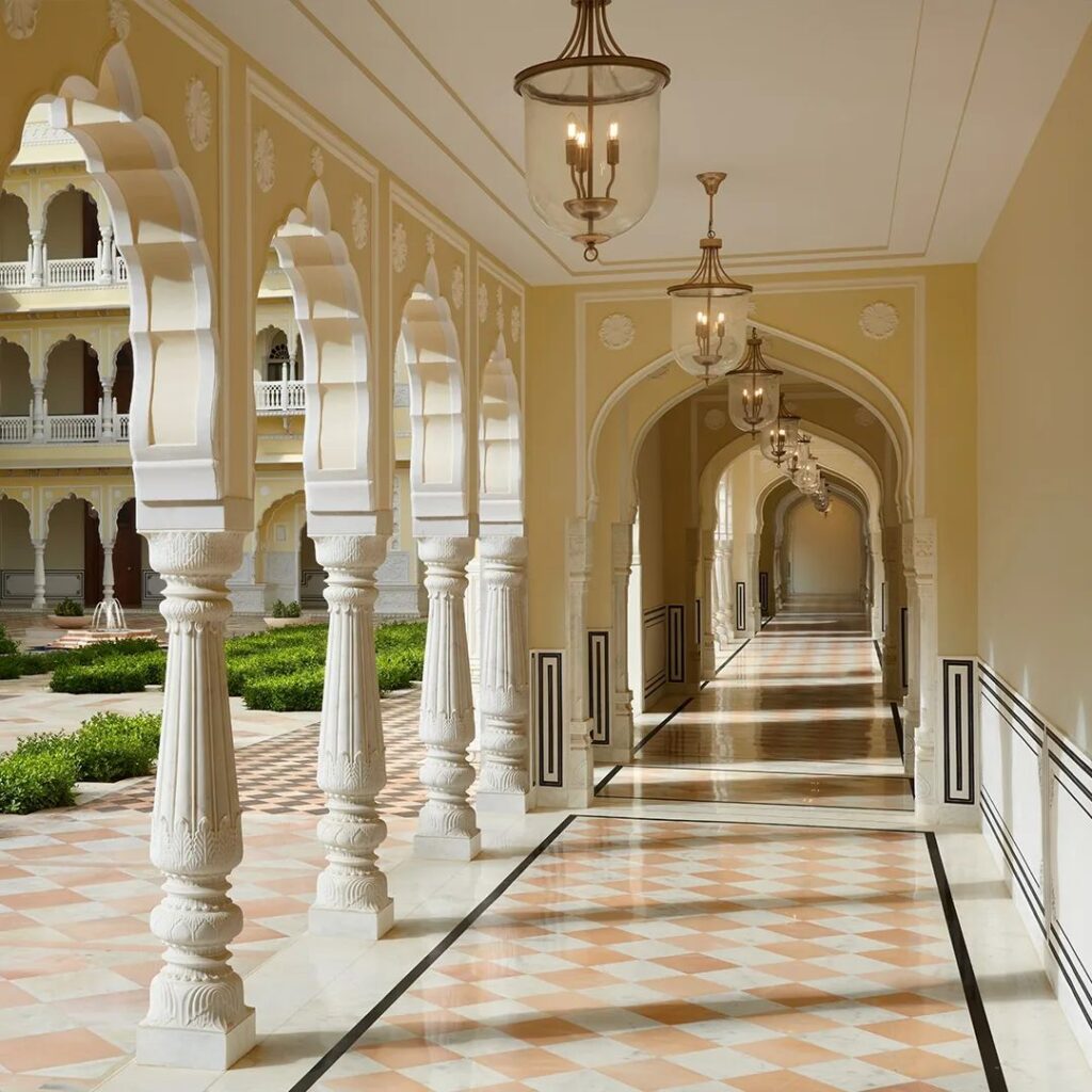 intricately carved columns flank marble walkways at the Hyatt Regency Jaipur Mansarovar hotel
