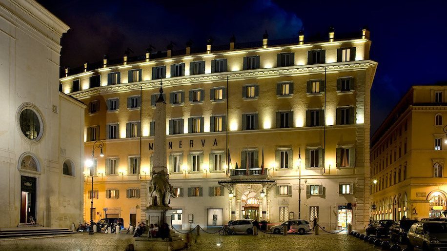 The facade of the Grand Hotel Minerva, lit up at night, which is set for a new opening