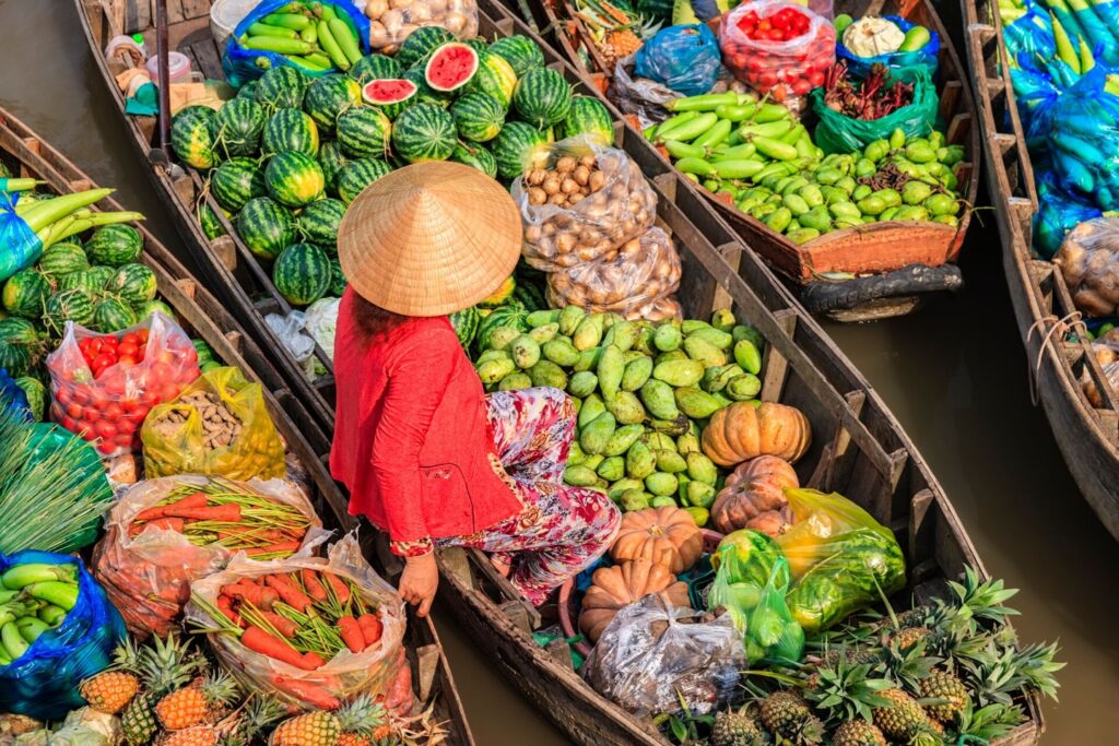 Woman selling produce on a boat on the Mekong River Vietnam