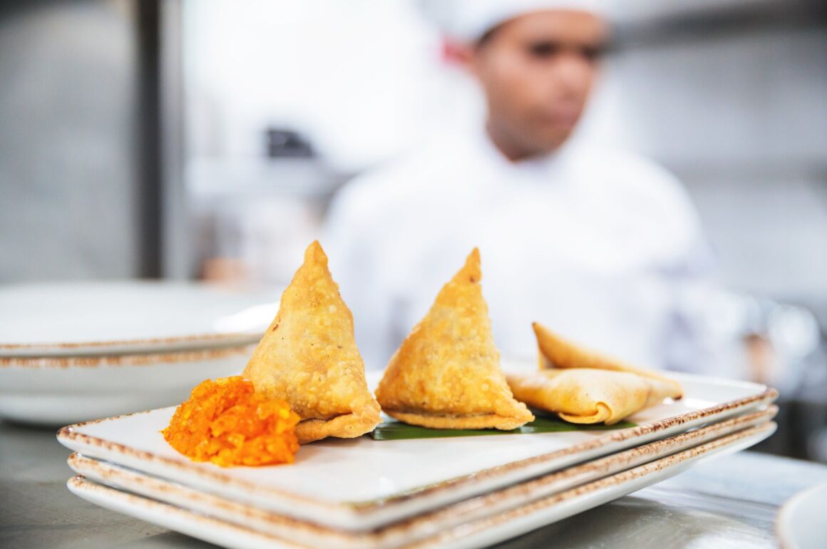 Samosas with condiments in kitchen