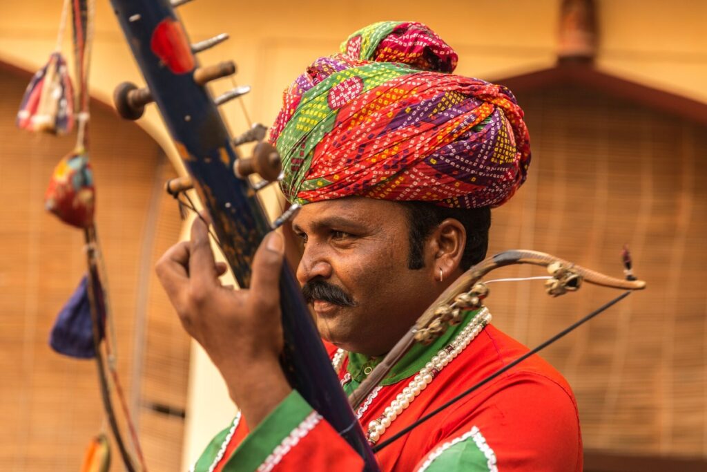 Indian man plays traditional musical instrument in Jaipur Rajasthan India