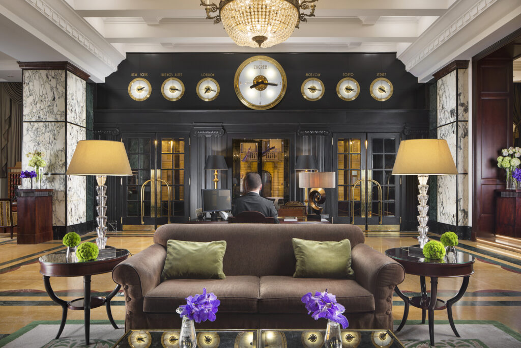 The plush lobby of the Hotel Esplanade Zagreb who’s art deco style with marbled walls, wooden floors and comfy, plush furnishings 