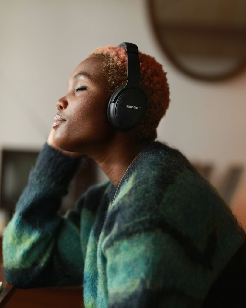 woman listening to Bose headphones