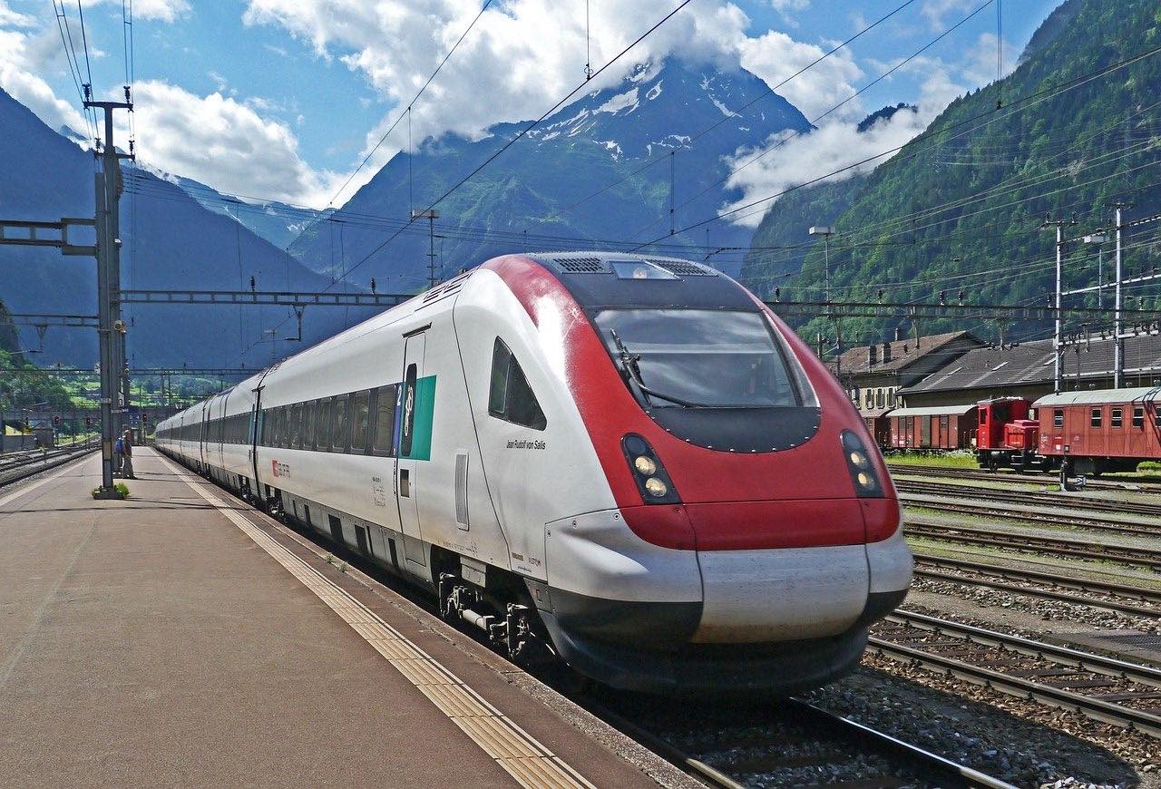 Closeup of the transalpine express on platform with mountains in background