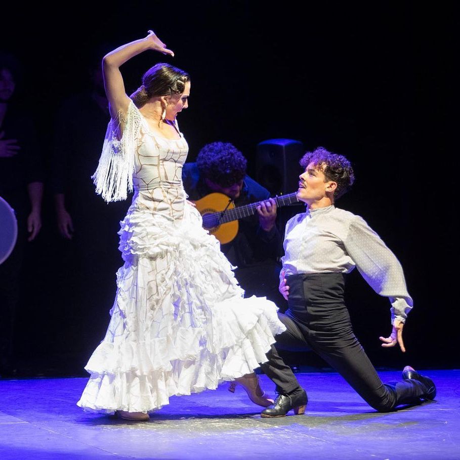 A female flamenco dancer danced round a male who’s is kneeling on the floor with guitarist in the background