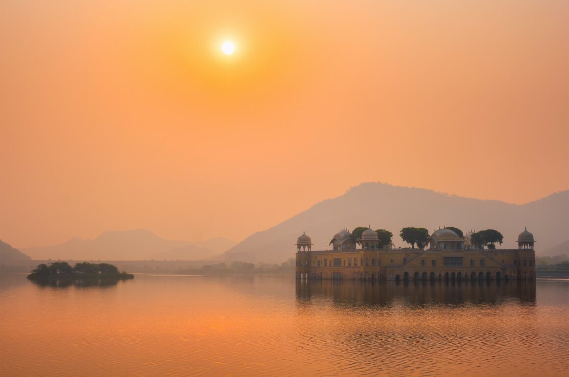 palace on lake at sunset, india