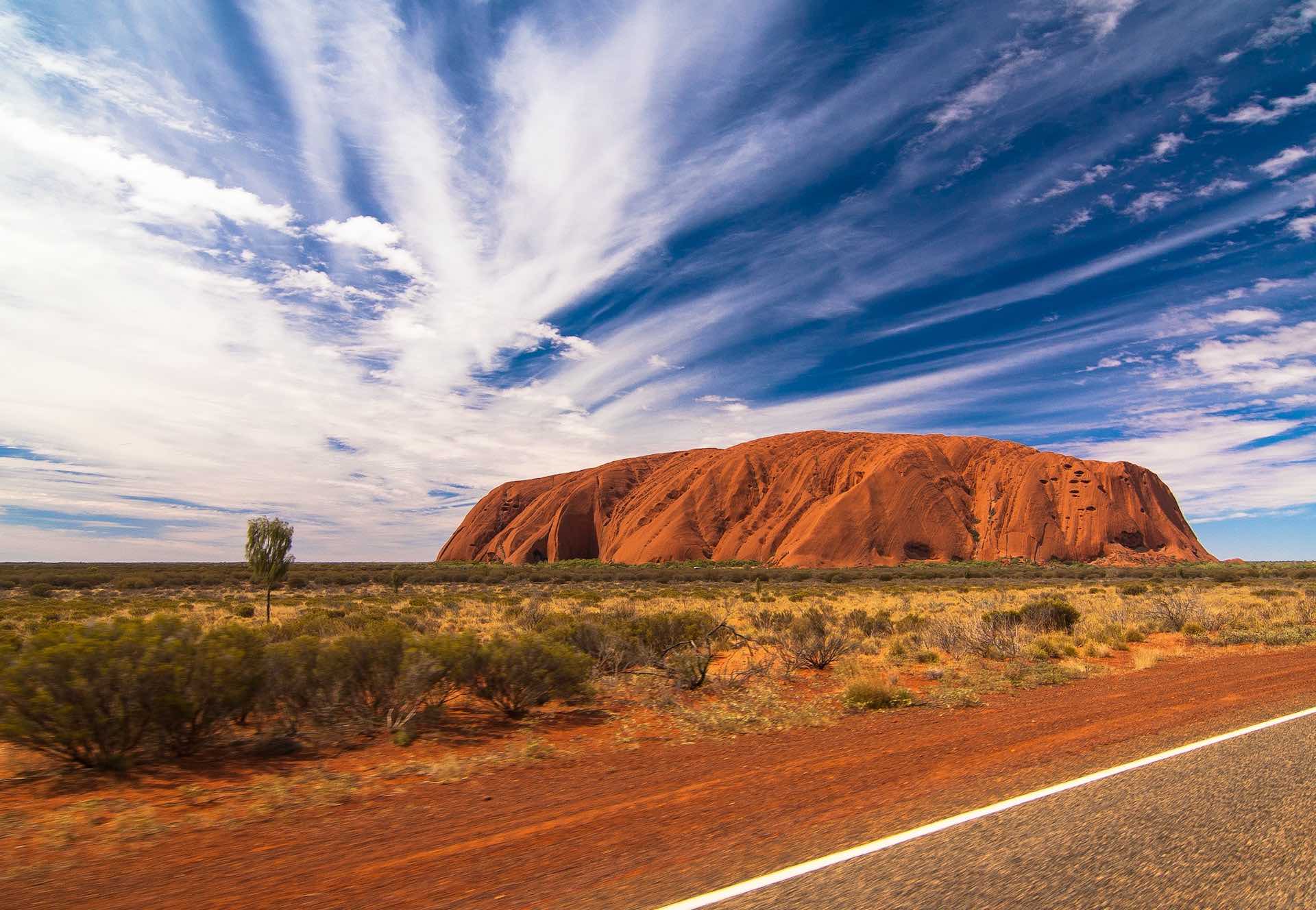 Ayers Rock against cloudy sky, Australian outback 