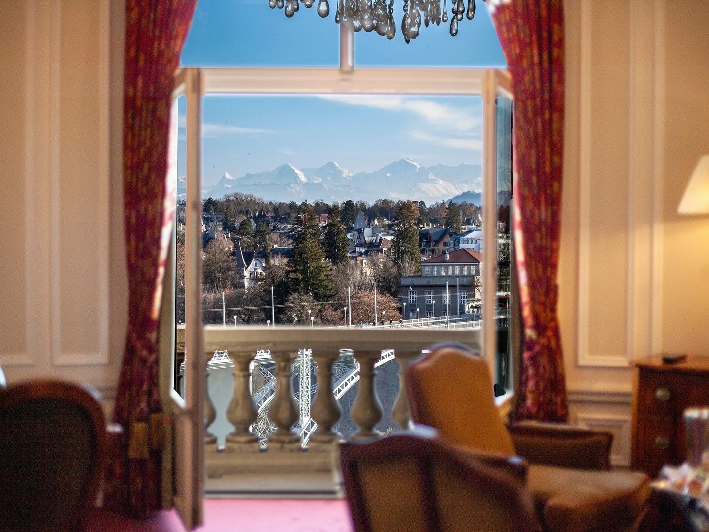 Interior of room at hotel belle view palace looking out of window with alps in background 