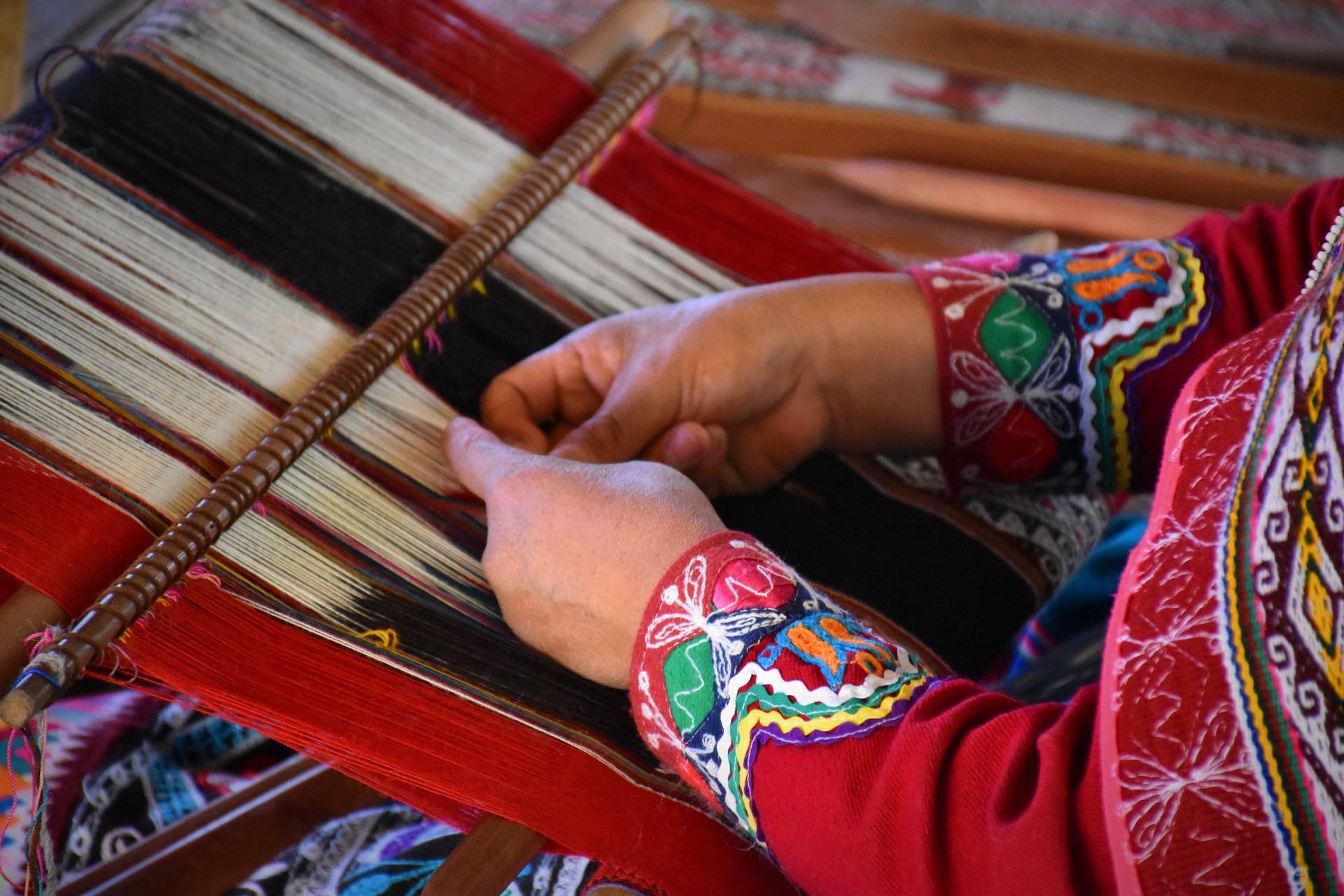 Close up of woman weaving traditional textiles in Peru