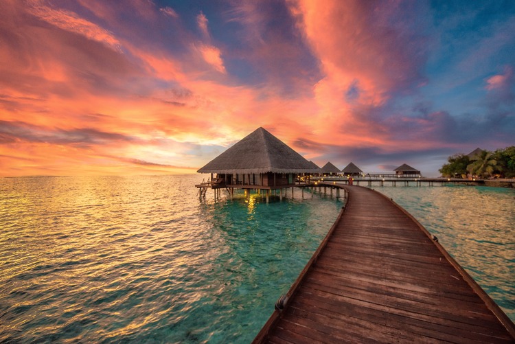 overwater bungalow at sunset