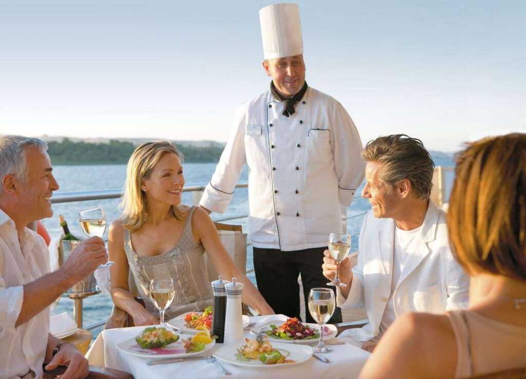 chef and guests chatting over dinner on Nile River cruise ship
